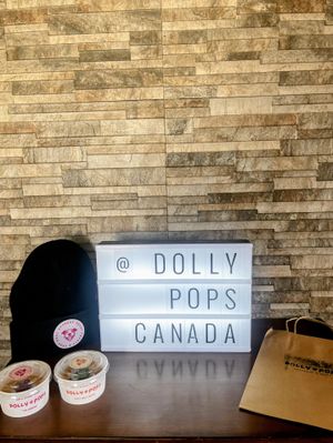 A sign reading @ Dolly Pops Canada